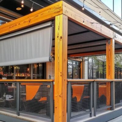 A wooden patio structure features a system of movable boards for adjustable shading.