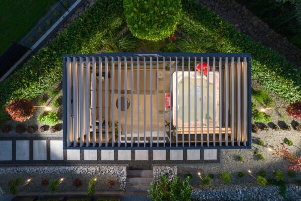 A top view of a pergola with a hot tub and seating area, featuring movable boards for pergolas to control sunlight.